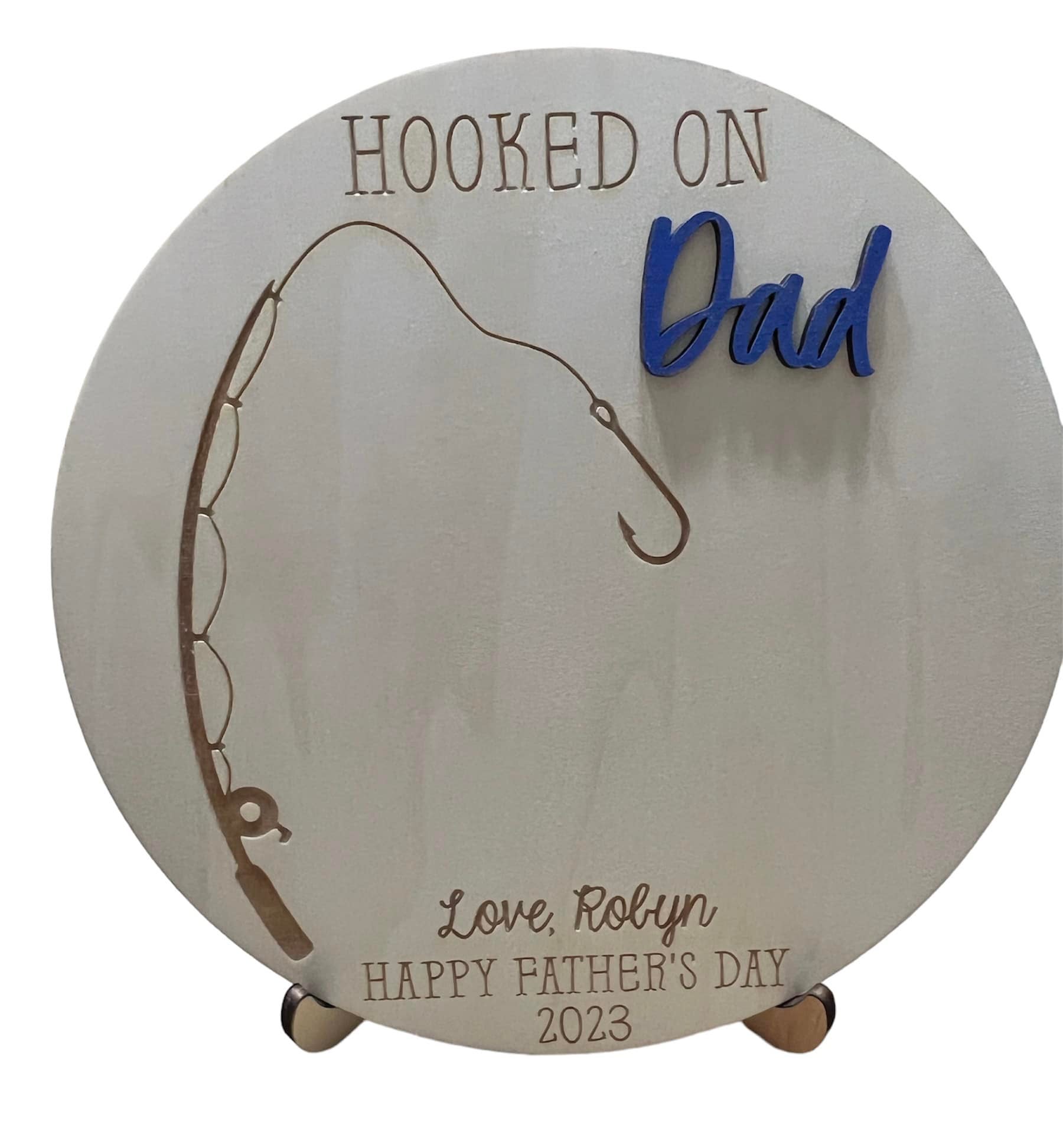 9 Inches & comes with stand. Hooked on dad handprint round. Can
